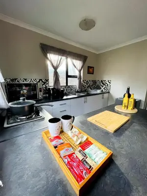 a kitchen with a table with food on it at The Shed - Capital Park in Pretoria