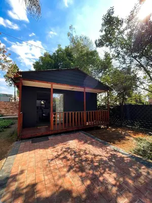 a small house with a porch and a patio at The Shed - Capital Park in Pretoria
