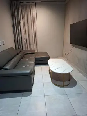 a living room with a couch and a table at 124 Brooks in Pretoria