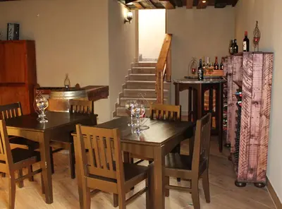 a dining room with wooden tables and chairs with wine glasses at Foreva Wild in Klipdrift