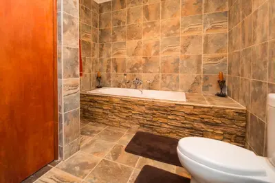 a bathroom with a toilet and a bath tub at Foreva Wild in Klipdrift