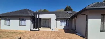 a house with white walls and a black roof at Ekuhlaleni a home away from home R7 in Pretoria