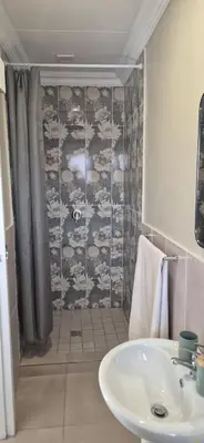 a bathroom with a sink and a shower at Ekuhlaleni a home away from home R7 in Pretoria