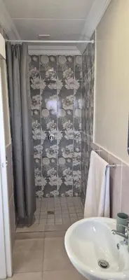 a bathroom with a sink and a shower at Ekuhlaleni a home away from home R7 in Pretoria