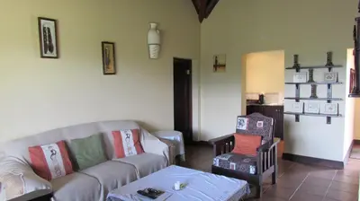 a living room with a couch and a chair at 205 Zebula 2 bedroom cottage in Warmbaths
