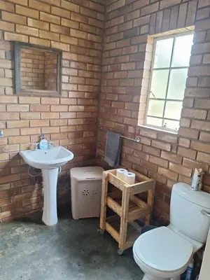a bathroom with a toilet and a sink at Oppieplaas in Alldays