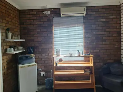 a kitchen with a refrigerator and a brick wall at Oppieplaas in Alldays