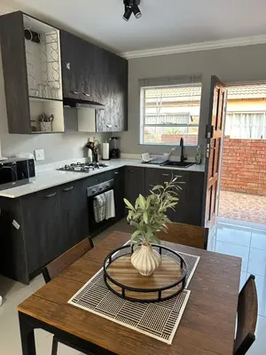 a kitchen with a table with a vase on it at The Olive Nook 2-Bed in Midrand in Midrand