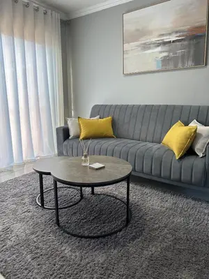 a living room with a couch and a coffee table at The Olive Nook 2-Bed in Midrand in Midrand