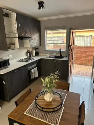 a kitchen with a table with a vase on it at The Olive Nook 2-Bed in Midrand in Midrand