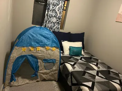a small room with a bed with a tent at Peaceful Cute Apartment in Pretoria