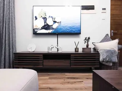 a living room with a tv on a wall at A home away from home cosy luxurious compact 1 bed in Centurion