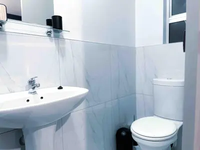 a white bathroom with a sink and a toilet at A home away from home cosy luxurious compact 1 bed in Centurion