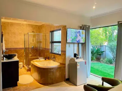 a large bathroom with a tub and a shower at A Private Room with a Private Entrance in Olifantsfontein
