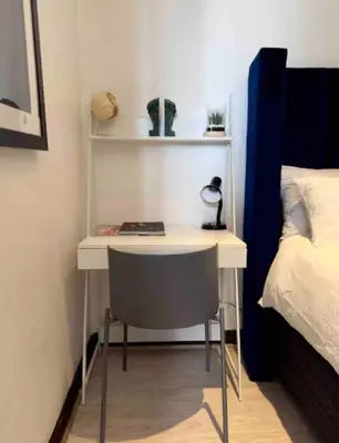 a desk with a chair next to a bed at A Private Room with a Private Entrance in Olifantsfontein