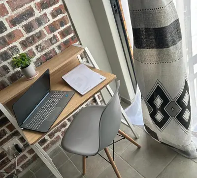 a desk with a laptop and a chair on it at Gwendolen in Pretoria