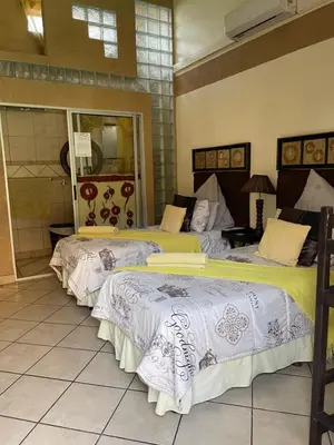 a couple of beds in a room at Texas Guesthouse in Phalaborwa