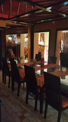 a dining room with a table and chairs in a room at Texas Guesthouse in Phalaborwa