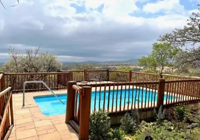 a swimming pool with a wooden fence around it at 205 Zebula, 4 bedroom house in Warmbaths