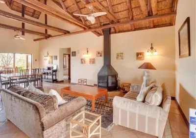 a living room with two couches and a fireplace at 205 Zebula, 4 bedroom house in Warmbaths