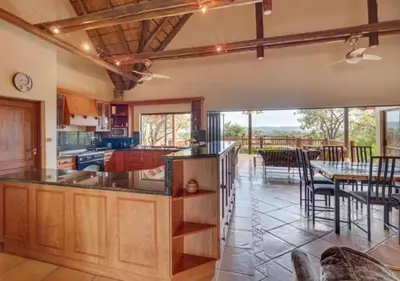 a kitchen with a table and a dining room at 205 Zebula, 4 bedroom house in Warmbaths