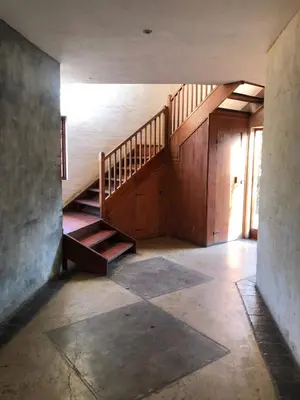 an empty hallway with stairs in an old house at Cherry Lane at Cherry Grove in Dullstroom