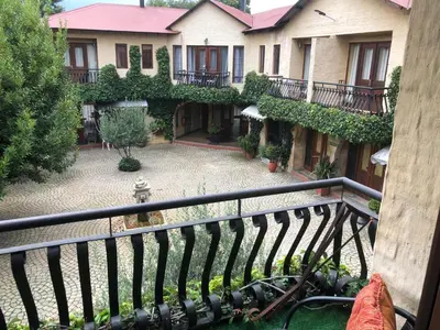 a view from a balcony of a house with a courtyard at Cherry Lane at Cherry Grove in Dullstroom