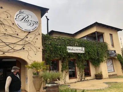 a man walking in front of a building at Cherry Lane at Cherry Grove in Dullstroom