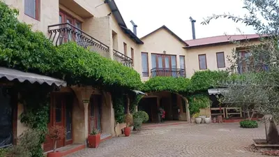 a courtyard of a house with ivy on the walls at Cherry Lane at Cherry Grove in Dullstroom