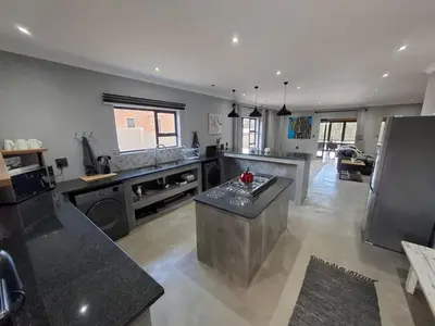 a large kitchen with an island in the middle at The Goose Guesthouse in Dullstroom
