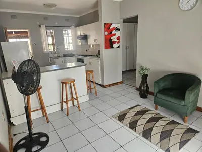 a kitchen with a counter and a green chair in it at Peace at 68 in Nelspruit