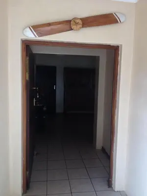 a door to a hallway with a ceiling fan at Pilot Inn Accommodation in Kempton Park