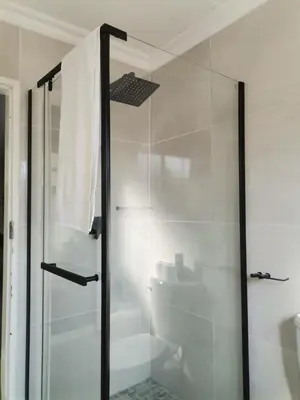 a bathroom with a glass shower with a toilet at The Reeds Private Garden House in Centurion