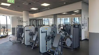 a gym with several rows of treadmills and machines at Luxury Escape at Ellipse 1-Bed, Kitchen, Wi-Fi & Free Parking in Midrand