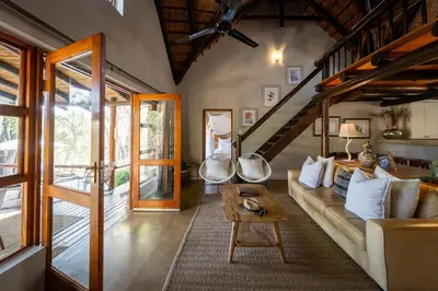 a living room with a couch and a table at Karongwe - Kuname Safari Lodge in Hoedspruit