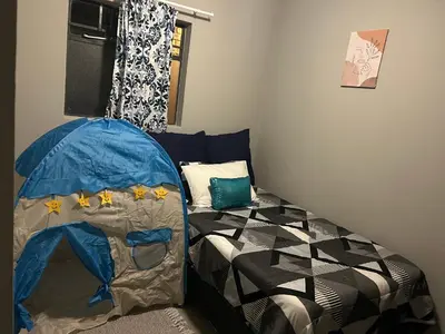a bedroom with a bed with a tent in it at Cosy Apartment in Pretoria