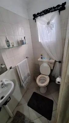 a small bathroom with a toilet and a sink at Casa Maya in Pretoria