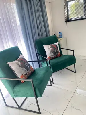 two green chairs sitting next to a window at Lakeside Studio Sleeps max 2 in Benoni