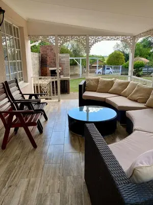 a living room with a couch and chairs and a table at Lakeside Studio Sleeps max 2 in Benoni