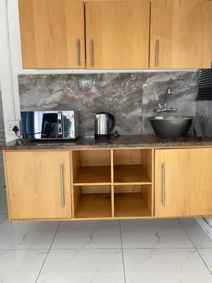 a kitchen counter with a sink and a microwave at Lakeside Studio Sleeps max 2 in Benoni