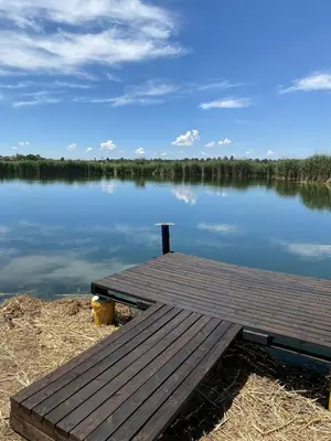 a wooden dock sitting on the shore of a lake at Lakeside Studio Sleeps max 2 in Benoni