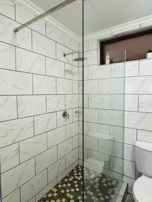 a bathroom with a glass shower with a toilet at Apartment with stunning scenic views in Pretoria