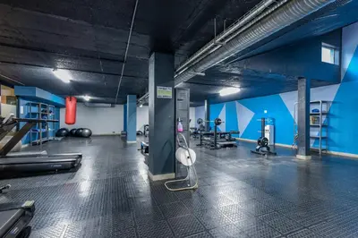 a gym with cardio equipment and people in the background at Circa Lynwood Accommodation in Pretoria