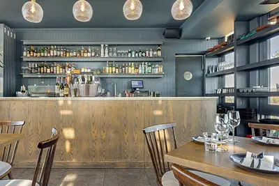 a restaurant with a wooden bar with tables and chairs at Menlyn Luxury Studio KingBed XL Free Parking 137 in Pretoria