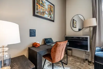 a room with a desk with a laptop on it at Menlyn Luxury Studio KingBed XL Free Parking 137 in Pretoria
