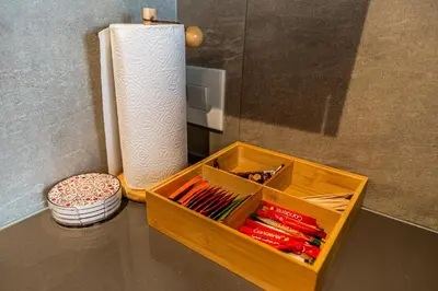 a wooden box sitting on a counter next to a roll of paper towels at Menlyn Luxury Studio KingBed XL Free Parking 137 in Pretoria