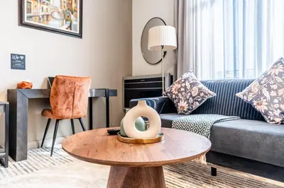 a living room with a couch and a table at Menlyn Luxury Studio KingBed XL Free Parking 137 in Pretoria