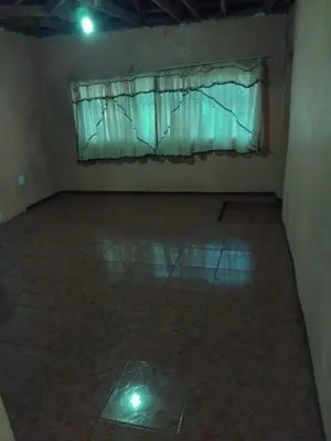 an empty room with a window and a tiled floor at Lutendo accommodation in Thohoyandou