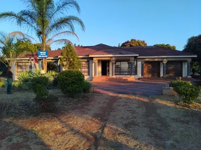 a house with a palm tree in front of it at Lutendo accommodation in Thohoyandou
