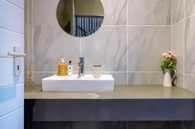 a bathroom with a white sink and a mirror at AlimamaSpacesThe Mansons Cascades Villa in Midrand